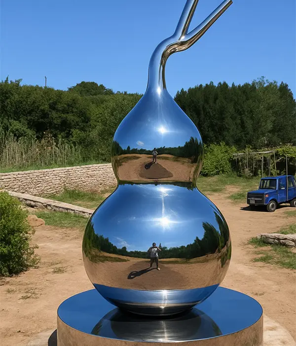 Finished mirror polished stainless steel gourd sculpture installed outdoors