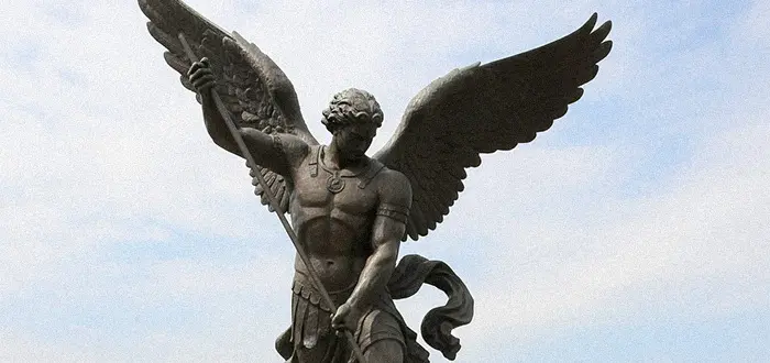 Close up of bronze St Michael archangel statue wings and spear detail