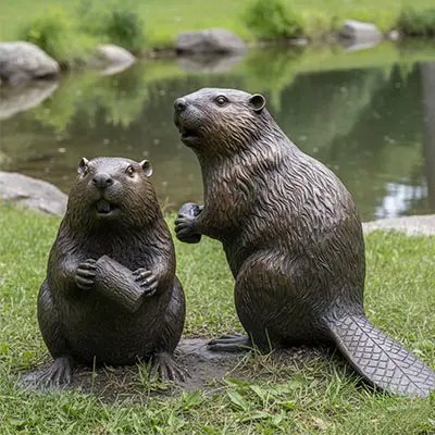 Pair of bronze beaver statues standing on rock