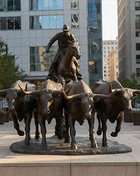 Bronze cattle drive sculpture group with cowboy