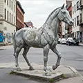 Cheap painted cement horse statue with peeling surface and color loss