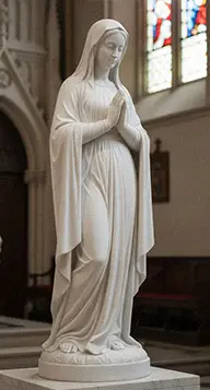 Hand carved white marble Mary statue detail showing drapery