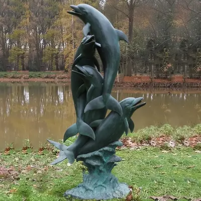 Bronze dolphin water fountain statue spraying water in pond