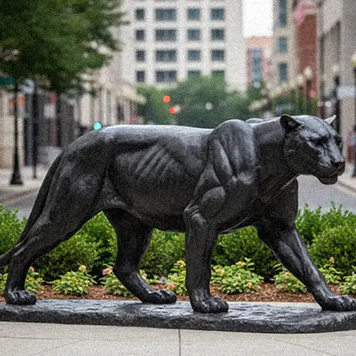 Sleek black panther statue walking outdoor sculpture