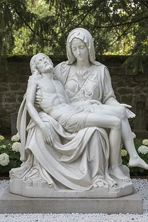 Michelangelo Pieta statue replica in white marble showing Mary cradling the body of Jesus
