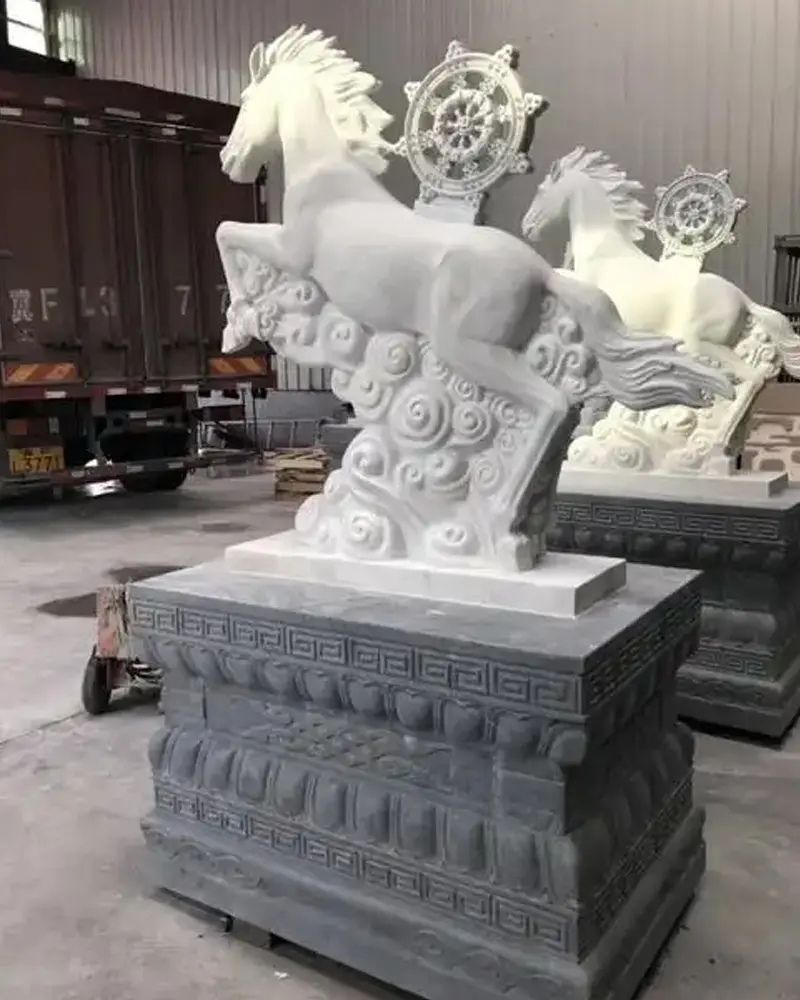 Pair of white marble horse statues standing on pedestals for driveway entrance