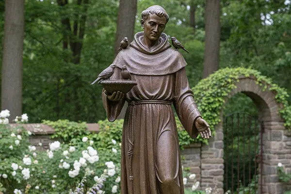 St Francis statue with bird feeder bowl for garden