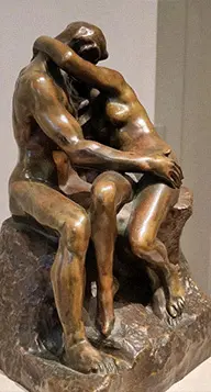 Bronze The Kiss sculpture by Rodin showing two lovers embracing