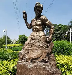 Self Made Man bronze statue of a man carving himself out of rock