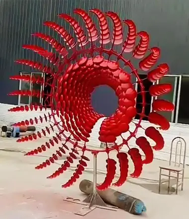 Red painted kinetic wind sculpture abstract modern art