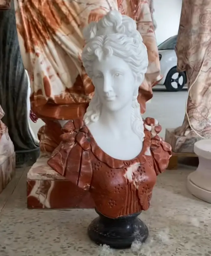 A decorative colored marble female bust.