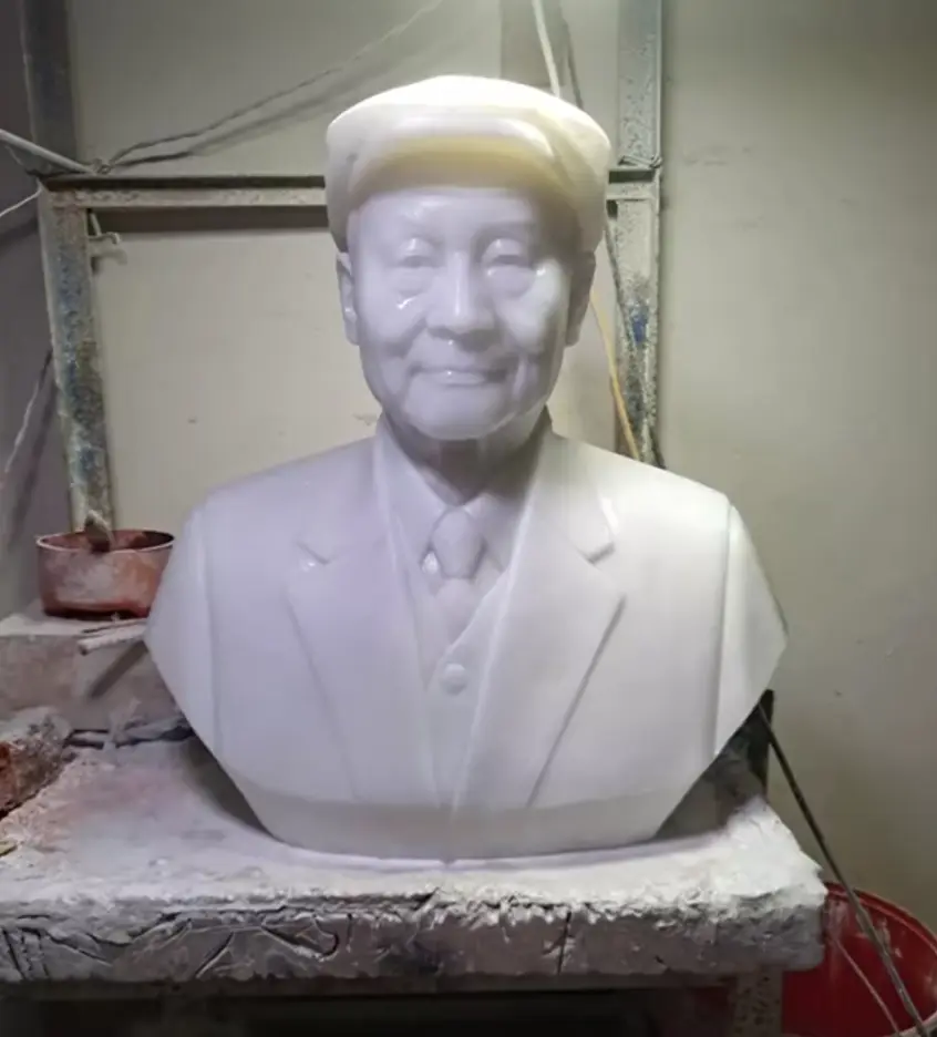 Hand-carved white marble custom portrait of a man.
