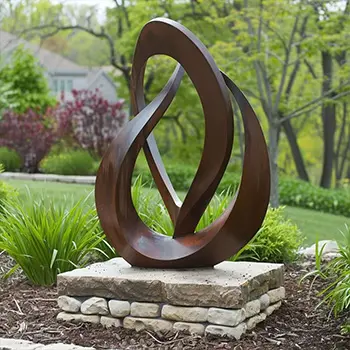 Installing abstract corten steel flame sculpture on stone base
