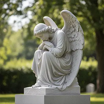 White marble weeping angel headstone monument in cemetery