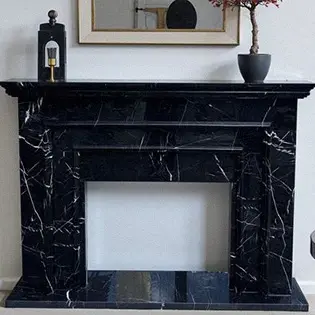 Black marble fireplace surround against white wall interior design