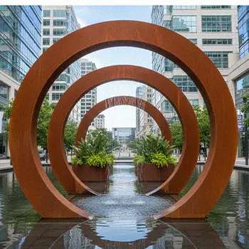 Corten steel moon gate rings water feature in garden