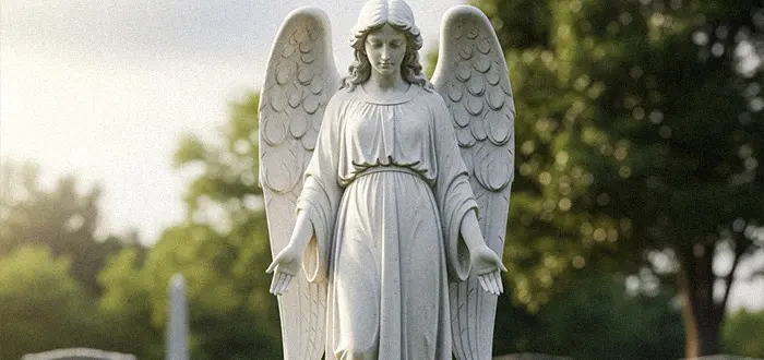 Large standing angel statue beside black granite headstone with bible verse