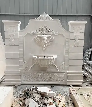 Custom carved white marble wall fountain with elephant head