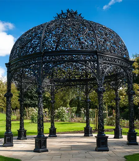 Black wrought iron birdcage gazebo interior view looking out to garden