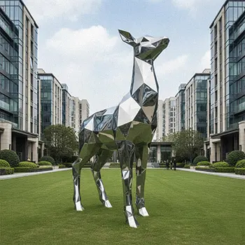 Large faceted stainless steel stag deer statue on green lawn