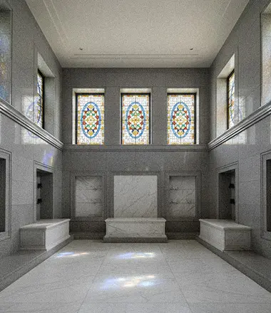 Classic white marble mausoleum entrance with columns and statues