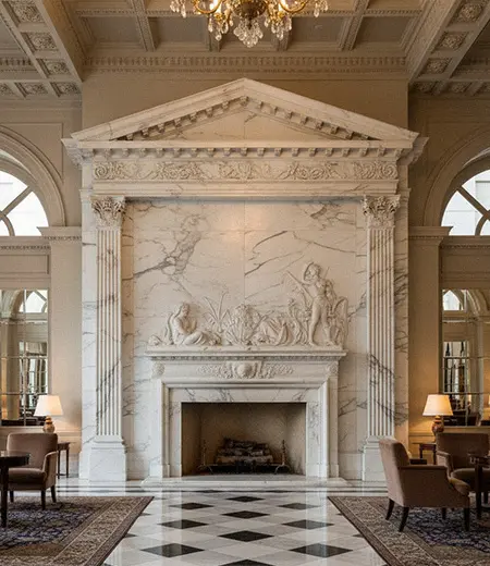 Grand white marble floor to ceiling fireplace overmantel in luxury hall