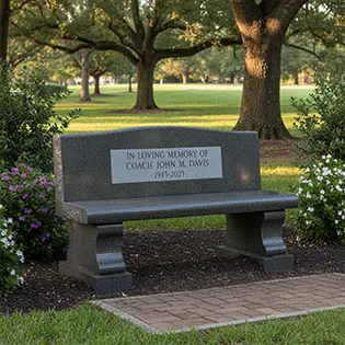 Granite memorial bench with engraved text in park