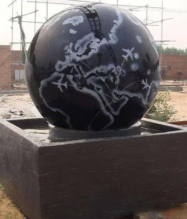 Black granite rolling sphere fountain with engraved world map
