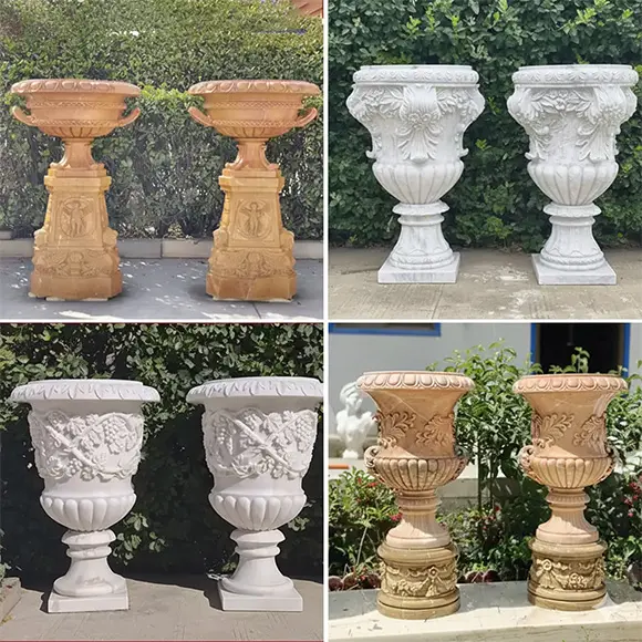 Pair of large antique terracotta or marble garden urns on pedestals
