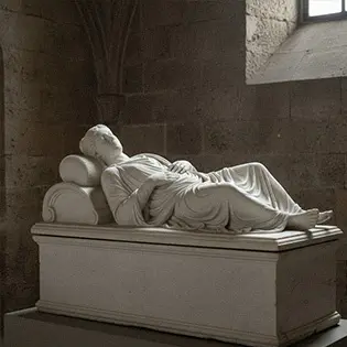 Marble sarcophagus with life-size sleeping statue on lid