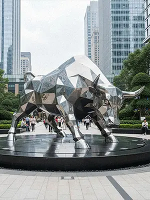 Mirror polished stainless steel faceted bull statue reflecting building