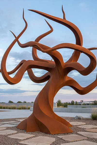 Abstract corten steel tree sculpture with twisted branches