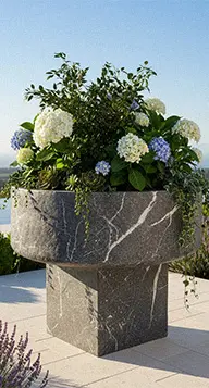 Large black marble round planter pot with flowers