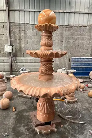 A life sized three-layer red granite rolling fountain in the factory
