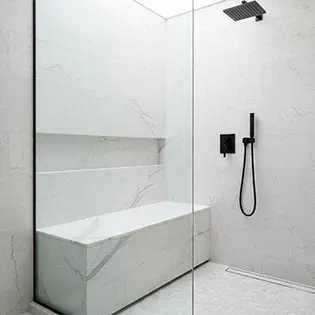 White marble shower bench matching bathroom tiles
