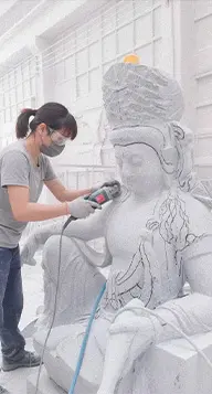 Artist hand carving white marble statue in factory