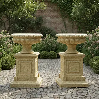 Pair of large stone garden planters on pedestals