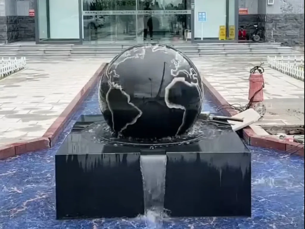 Black Rolling Stone Fountain with World Map Imprint