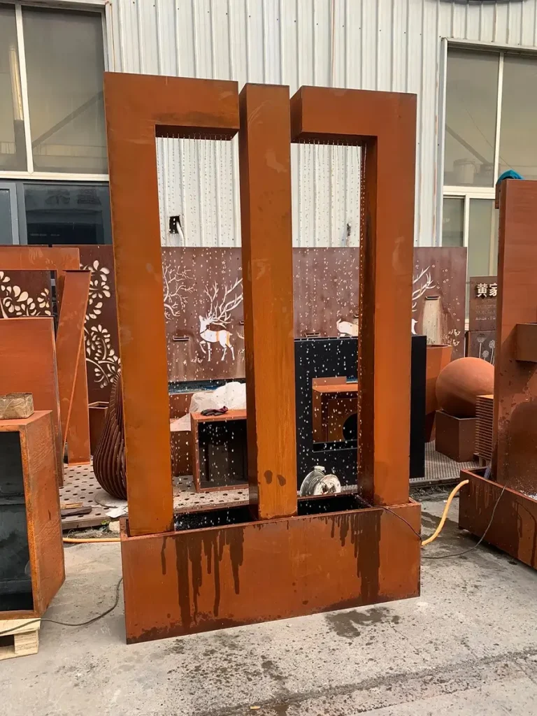 Weathering steel double water curtain fountain undergoing factory testing prior to shipment.
