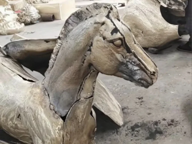 hand chasing bronze horse