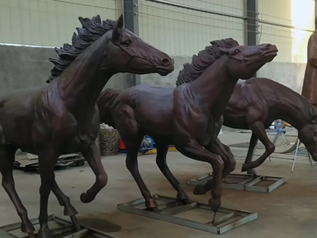Applying hot chemical patina on bronze horse sculpture to achieve museum-quality finish