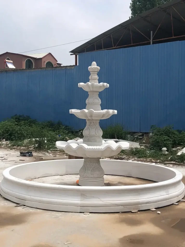 Large white marble garden fountain assembled in factory before shipping, made from natural quarried stone not bonded marble.
