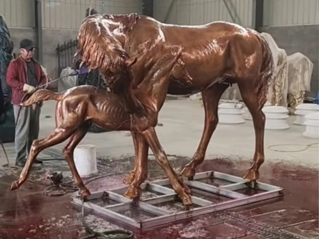 Lost wax casting process showing hot chemical patina applied to a bronze horse statue surface