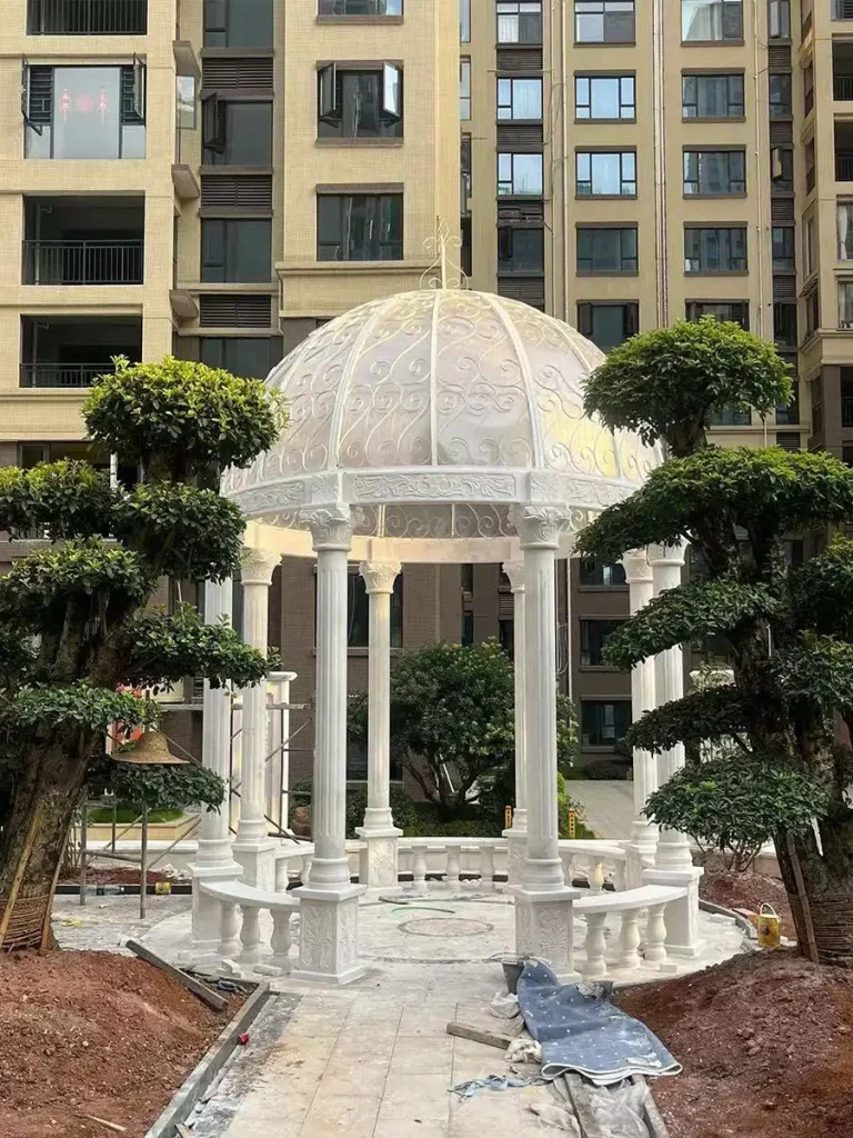 Luxury marble garden gazebo fully installed in outdoor landscape setting under natural daylight