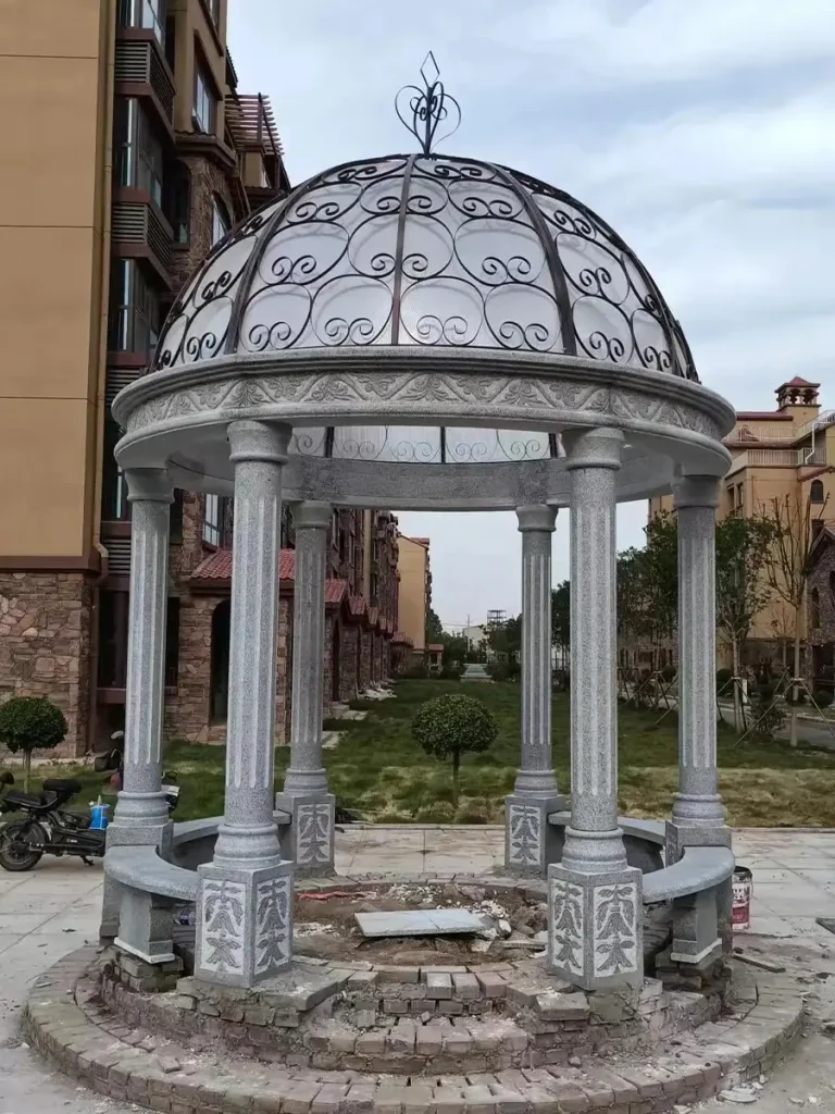 Outdoor marble column pavilion finished as architectural focal point in estate courtyard.