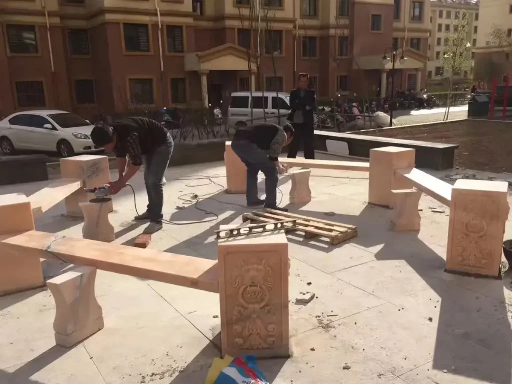 Installation process of solid marble columns for a large garden gazebo on reinforced concrete foundation.