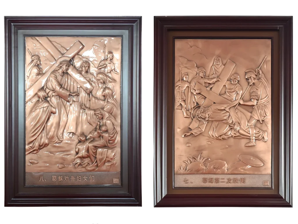 Outdoor bronze relief plaques showing Station VII Jesus falling the second time and Station VIII Jesus comforting the women of Jerusalem in high-relief casting