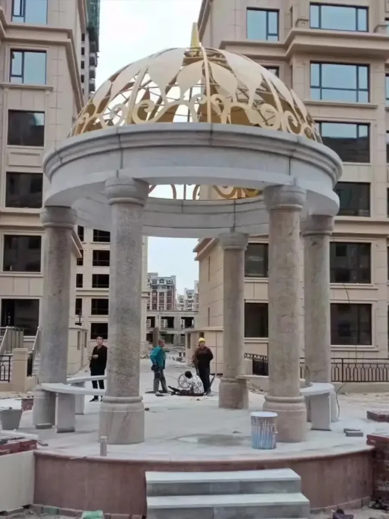 Stone pavilion installation showcasing solid marble construction and balanced proportions.