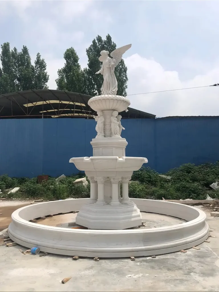 Three-tier natural marble fountain finished in factory yard, showing solid block carving and structural basin thickness.