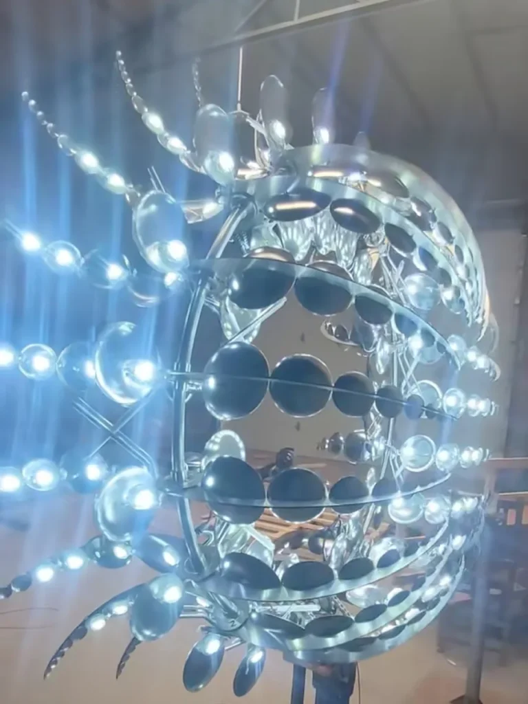 A close-up of a rotating kinetic sculpture made from 316L Marine Grade stainless steel, showing a mirror finish that resists micro-pitting and maintains exact equilibrium.